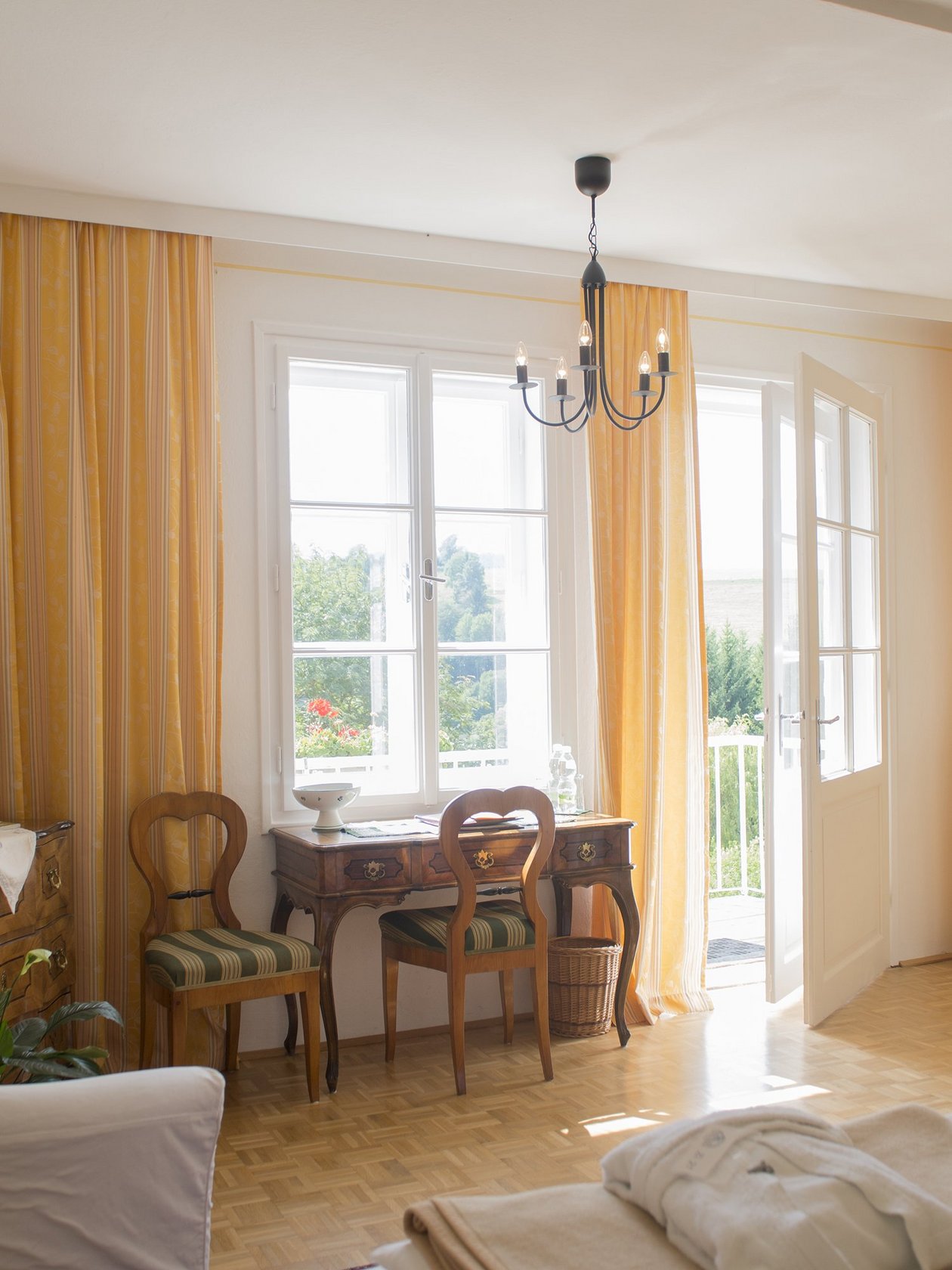 Bright and Airy Living Room A spacious living room featuring large windows, wooden furniture, and yellow curtains for a welcoming ambiance.